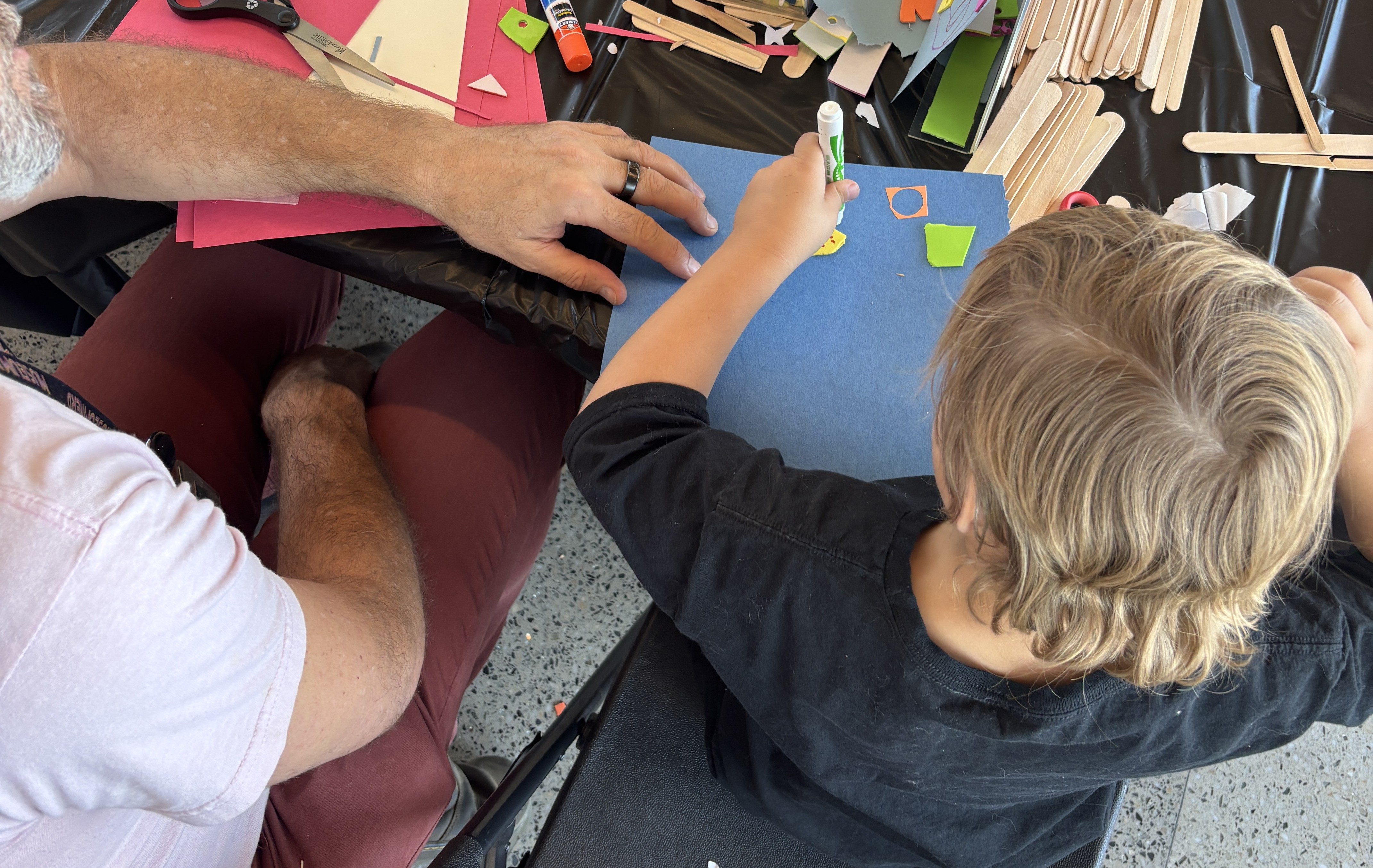 Picture of an adult and child working on a craft item